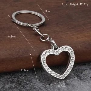 Sparkling silver heart keychain with inlaid rhinestones on a rustic wooden background
