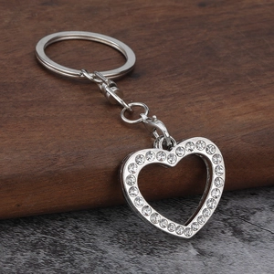 Detail of silver heart keychain with inlaid rhinestones and hollow photo slot