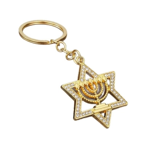 Gold Star of David keychain with rhinestones and Menorah charm on white background