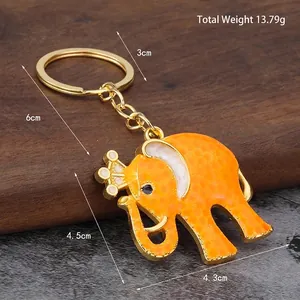Golden elephant crown keychain with orange enamel finish and a total weight of 13.79g