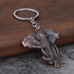Vintage elephant alloy keychain with bronze finish and detailed texture on stone surface