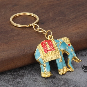 Detailed view of Southeast Asian style elephant keychain with blue and gold enamel finish