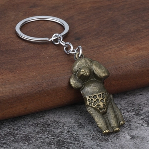 Detail of antique bronze poodle keychain featuring textured polka dots and metallic ring