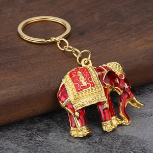 Detail of red enamel Thai elephant keychain with gold plating and ornate patterns