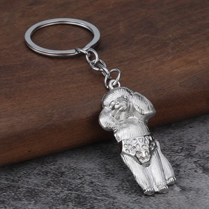 Detailed view of silver poodle keychain with intricate engraved metal hair textures