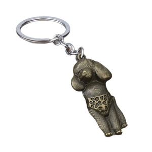 Antique bronze poodle keychain with dotted pants pattern on a silver keyring