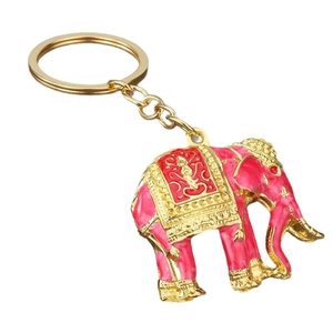 Golden elephant keychain with pink enamel finish and embossed saddle pattern on white background