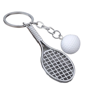 Mini tennis racket and ball keychain in polished silver metal on white background