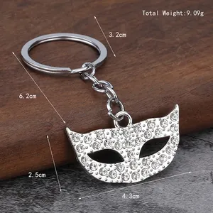 Elegant silver mask keychain with sparkling rhinestones and dimension markers