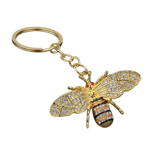 Sparkling bee keychain with gold metal plating, white rhinestones, and enamel accents