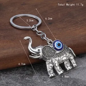 Silver elephant car keychain with blue Turkish evil eye and ethnic scroll patterns