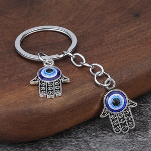 Detail of Hamsa Hand and Evil Eye car charm with vintage silver finish and resin textures