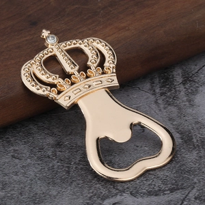 Golden crown bottle opener with diamond accent, elegant European souvenir on wood surface