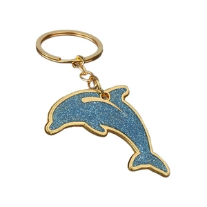 Blue glitter dolphin keychain with gold alloy frame on a simple circular key ring