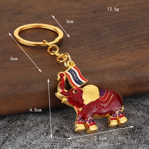 Hand-painted Thai elephant keychain in gold metal with red enamel and Thailand flag detail