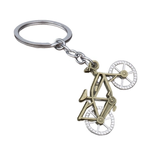 Vintage metal alloy bicycle keychain with bronze and silver dual-tone finish on white background