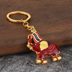 Macro shot of Thai style elephant keychain with red enamel coating and Thailand text