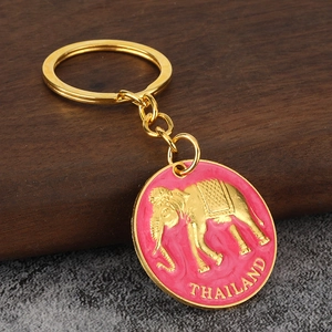 Detailed macro view of the pink enamel Thailand elephant keychain with golden metal finish