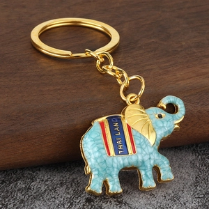 Detailed view of sky blue enamel elephant keychain with gold ring and Thailand text