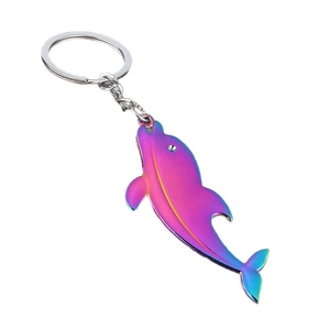 Polished metal whale keychain with iridescent rainbow gradient plating on white background