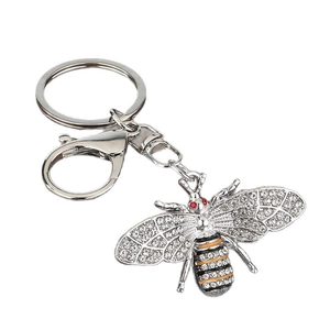 Bee keychain with rhinestone wings and black-yellow enamel stripes on white background