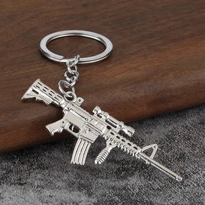 Miniature silver alloy rifle keychain featuring detailed scope and magazine components
