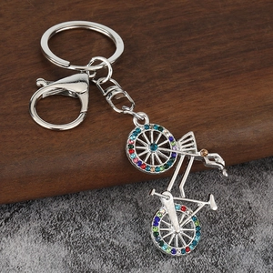 Macro detail of silver bike keychain featuring colorful rhinestones and secure lobster clasp
