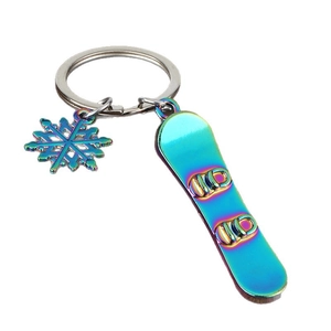 Rainbow plated metal skiing keychain featuring a mini snowboard and hollow snowflake charm