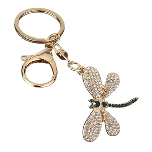 Elegant gold-tone dragonfly keychain with sparkling white and green crystals for bags