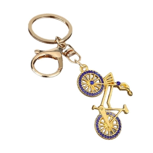 Gold bicycle keychain with blue rhinestones featuring a round ring and lobster clasp