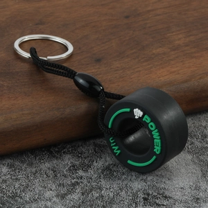 Detailed macro view of a creative black PVC tire keychain with green Win Power branding