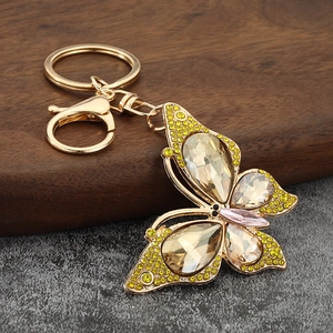 Sparkling crystal butterfly keychain with gold zinc alloy lobster clasp on wooden surface