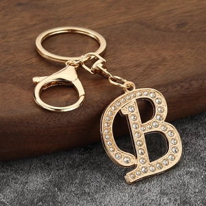 Detail of gold-plated letter B keychain featuring crystal rhinestones and lobster clasp