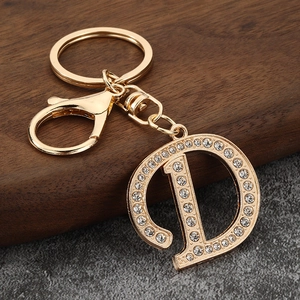 Detailed view of capital D keychain featuring gold plating and clear sparkling rhinestones