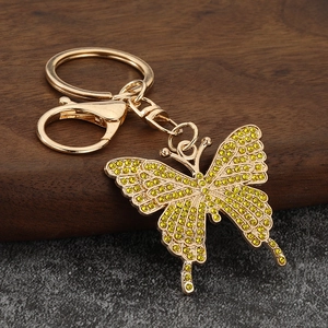 Macro view of butterfly keychain with yellow rhinestones and gold alloy lobster clasp