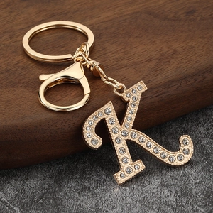 Detailed close-up of gold alloy letter K keychain with sparkling inlaid rhinestones