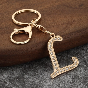 Detailed view of golden letter L keychain with sparkling rhinestones and lobster clasp