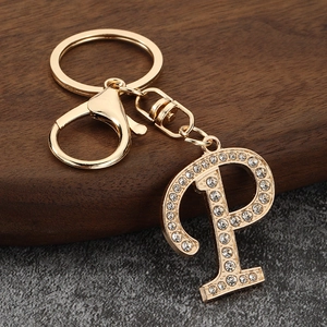 Close-up of gold-plated letter P keychain with sparkling rhinestones and lobster clasp