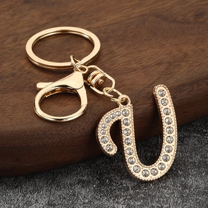 Close-up of golden letter U keychain with sparkling rhinestones and lobster clasp
