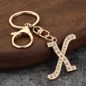 Detail of gold letter X keychain with sparkling crystal rhinestones and lobster clasp
