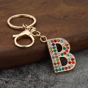 Close-up of letter B keychain with colorful rhinestones on gold metal base