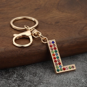 Detailed macro view of the gold-toned letter L keychain encrusted with colorful rhinestones