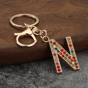 Detailed close-up of letter N keychain featuring vibrant multicolored rhinestones and gold metal