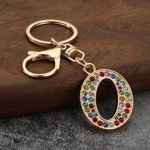 Detailed view of luxury gold-tone letter O keychain with vibrant colorful rhinestones