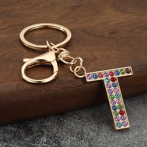 Macro view of gold letter T keychain with colorful rhinestones and lobster clasp