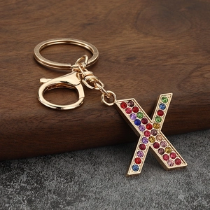 Detail of letter X keychain featuring colorful rhinestones and gold lobster clasp