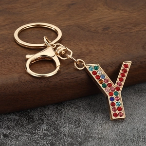 Macro shot of letter Y keychain with colorful rhinestones on a gold-plated alloy base