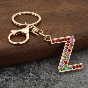 Macro detail of golden letter Z keychain featuring colorful inlaid rhinestones and clasp