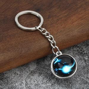 Detailed macro view of silver Capricorn zodiac glowing keychain with nebula pattern design