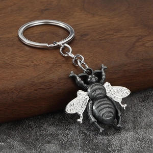 Minimalist vintage bee keychain in antique silver finish with textured wings and metal ring
